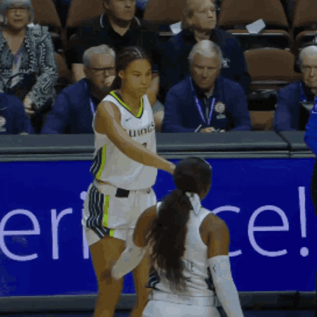a female basketball player wearing a jersey that says ' uines ' on it