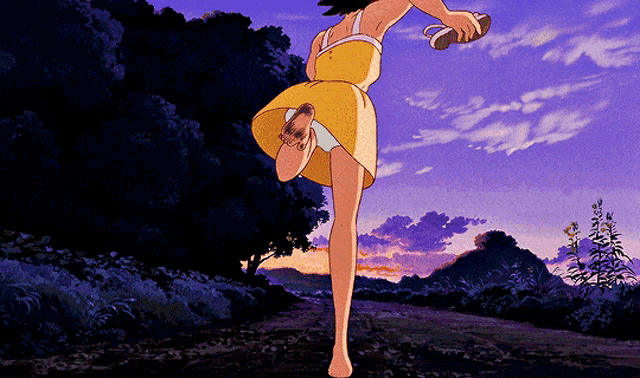 a girl in a yellow dress is running barefoot down a dirt road