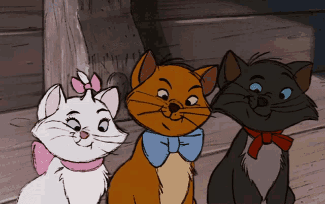 three cartoon cats are sitting next to each other and smiling for the camera