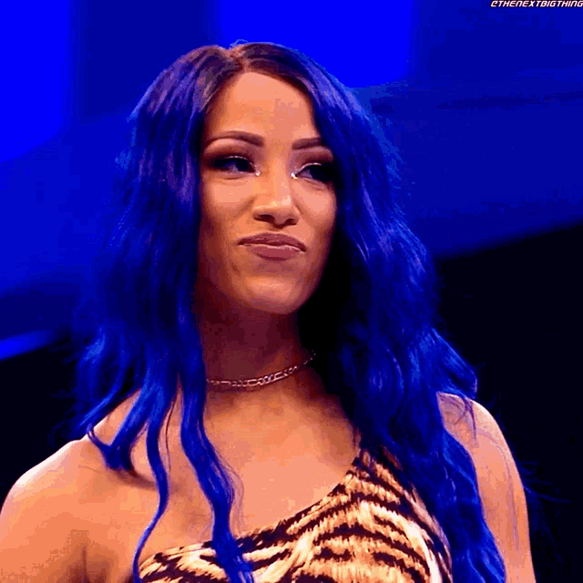 a woman with blue hair wearing a tiger print dress