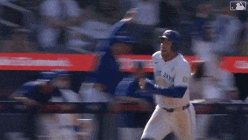 a baseball player is trying to catch a ball on the field while another player watches .