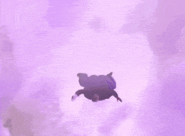 a man in a purple shirt with the letter a on it is jumping in the air