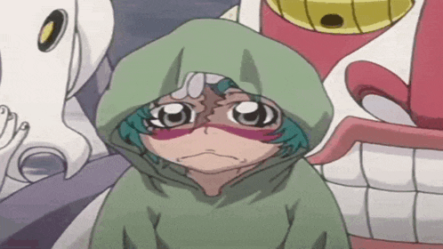 a little girl in a green hoodie with a hood