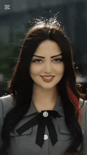 a close up of a woman 's face with a bow tie