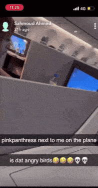 pinkpanthers next to me on the plane is dat angry birds written on a phone screen
