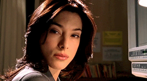 a close up of a woman looking at the camera