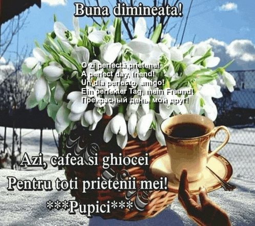 a cup of coffee sits on a saucer next to a vase of flowers