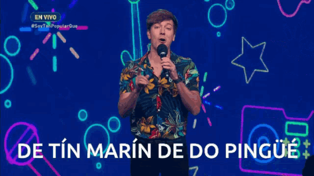 a man stands in front of a microphone with the words de tin marin de do pingue