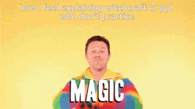 a man in a rainbow sweater stands in front of a rainbow with the words " magic " on the bottom