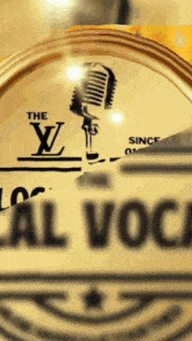 a louis vuitton logo with a microphone in the background