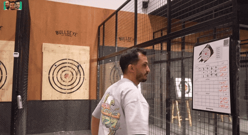 a man is standing in front of a bullseye target