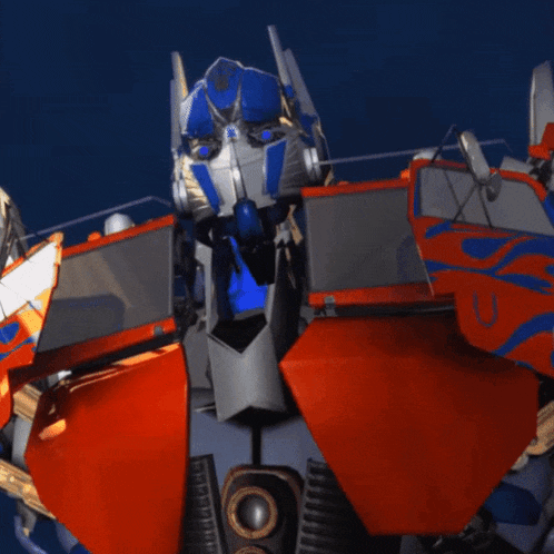 a close up of a robot 's head with the word optimus on it