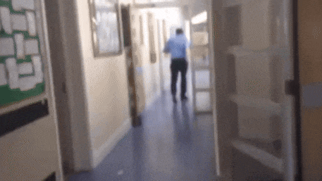 a blurry photo of a man walking down a hallway
