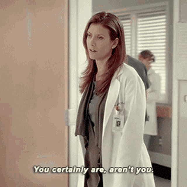 a woman in a white lab coat says " you certainly are aren 't you "