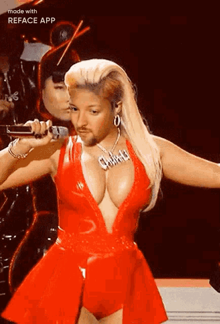 a woman in a red dress is singing into a microphone while wearing a necklace that says christina
