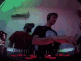 a group of men are playing music in a dark room with green lights