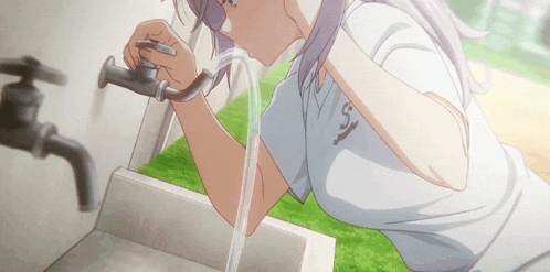 a girl in a white shirt with the letter s on it is washing her face