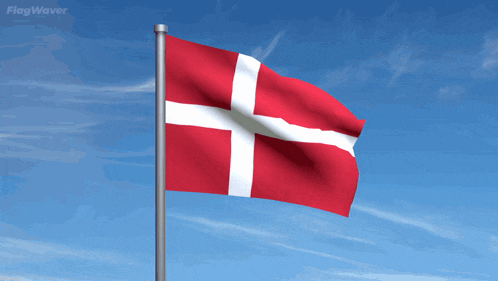 a red and white flag with a cross on it is flying in the wind
