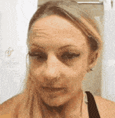 a close up of a woman 's face with a headband on .