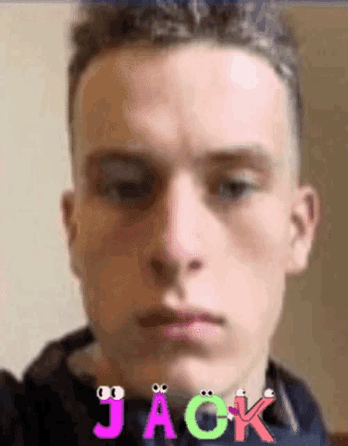 a close up of a young man 's face with the name jack written on it .