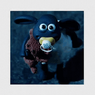 a cartoon sheep is holding a pacifier in its mouth