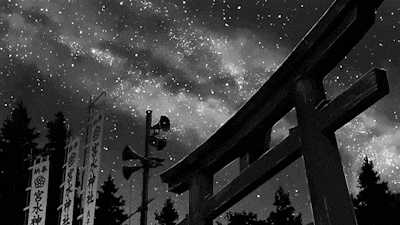 a black and white photo of a torii gate with chinese writing on it