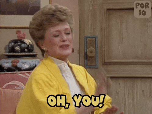 a woman in a yellow jacket is clapping and saying oh you