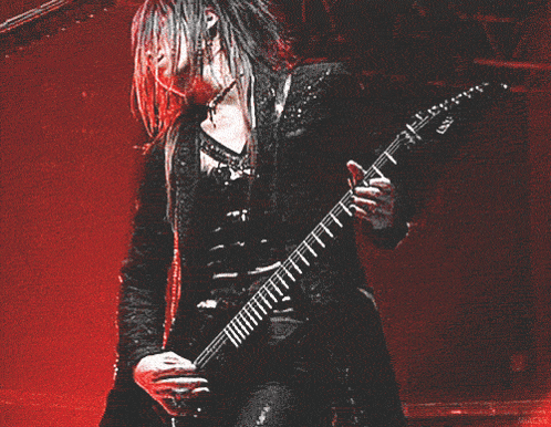 a man playing a guitar with the letter ss on the neck