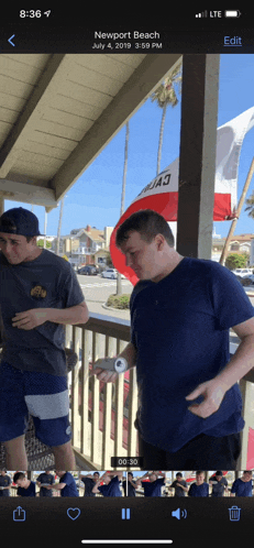a phone screen shows a photo from newport beach on july 4 2019