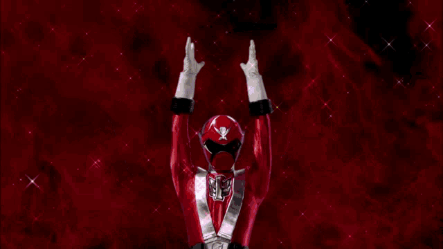 a red ranger is holding a pink light in his hands .