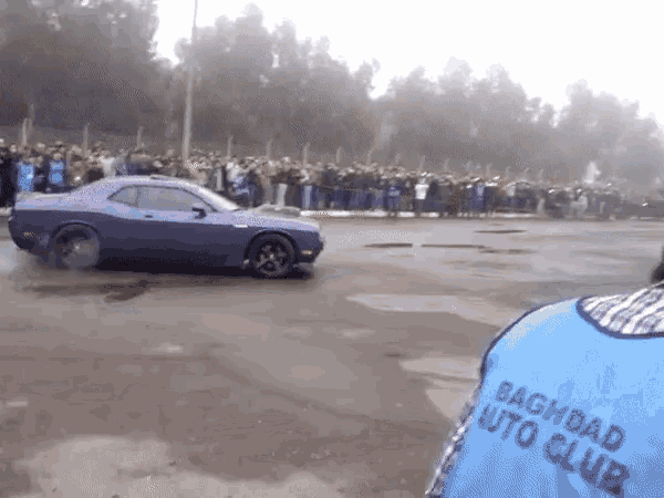 a blue baghdad auto club vest is being worn by a man