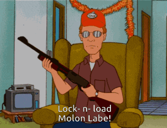 a cartoon character is sitting in a chair holding a gun and says " lock-n-load molon labe "