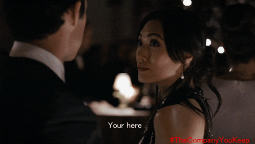 a man in a tuxedo says " i 'm here " in front of a woman