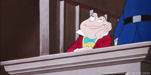 a cartoon frog is sitting at a podium with his hand on his chin ..