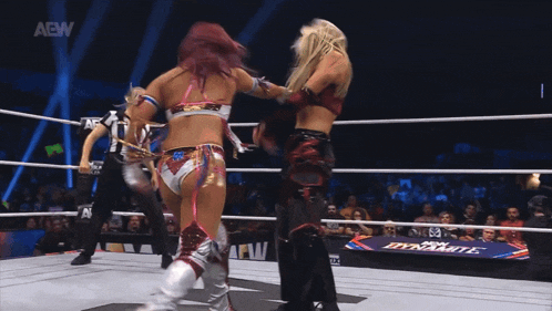 a woman is laying on the ground in a wrestling ring with aew written on the bottom
