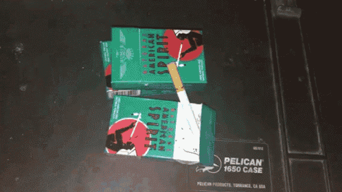 two packs of american spirit cigarettes sit on a pelican  1650 case