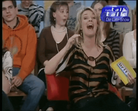 a woman laughs while holding a box of eric candy