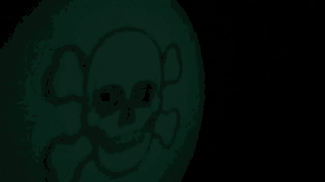 a glow in the dark skull and crossbones on a green background