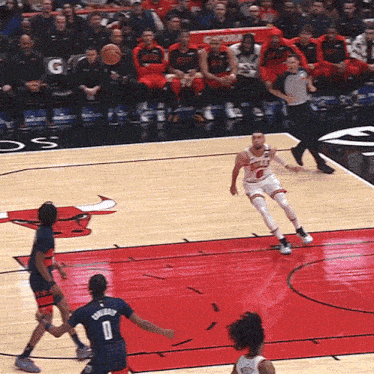 a basketball game is being played on a court with gatorade in the back