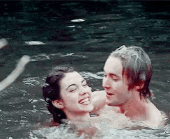 a man and a woman are swimming in the water