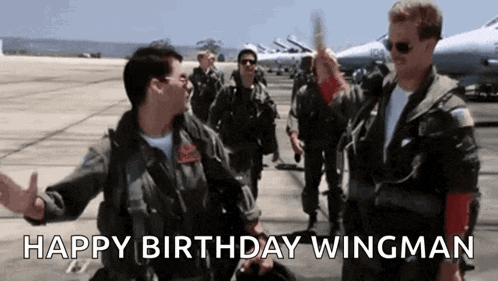 a group of military men are standing next to each other on an airport tarmac .