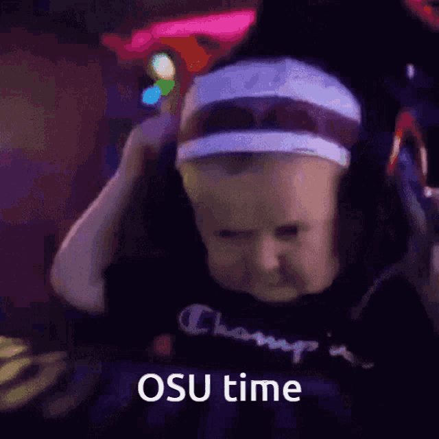 a baby wearing headphones with the words osu time written on the bottom