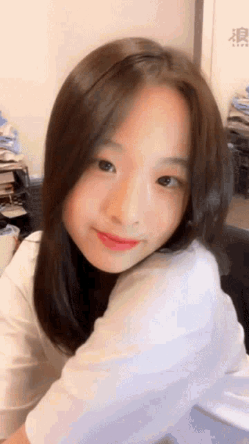 a close up of a woman 's face with a white shirt on