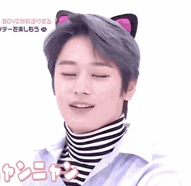 a young man wearing cat ears and a striped turtleneck