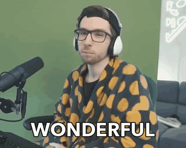 a man wearing headphones and a robe says wonderful in front of a green background