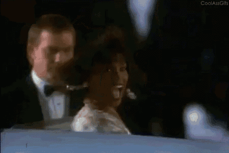 a man in a tuxedo is carrying a woman in a white dress