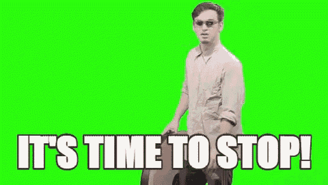 a man is holding a clock with the words `` it 's time to stop '' written on it .