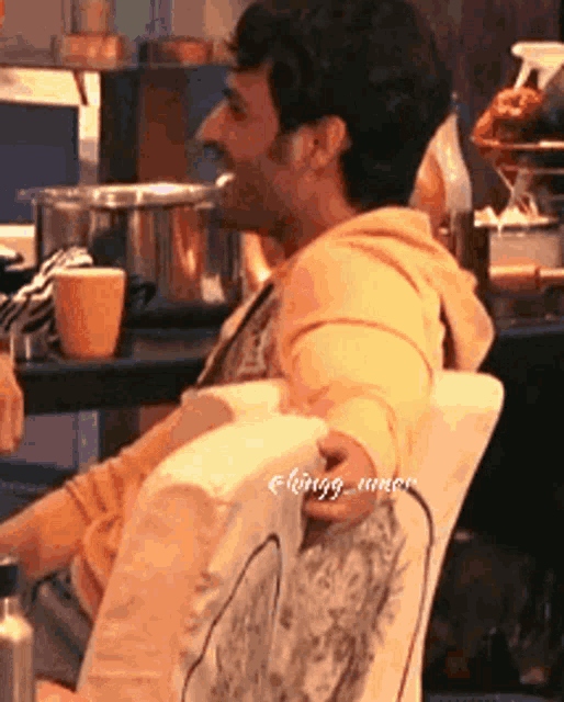a man is sitting in a chair with a picture of a dog on the back