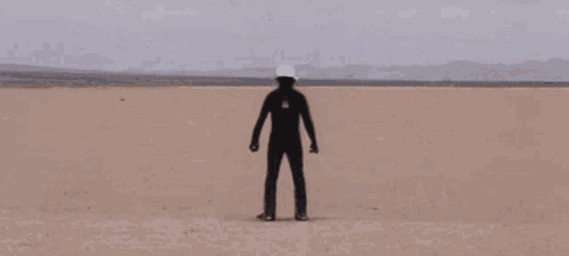 a black explosion in the middle of a desert .