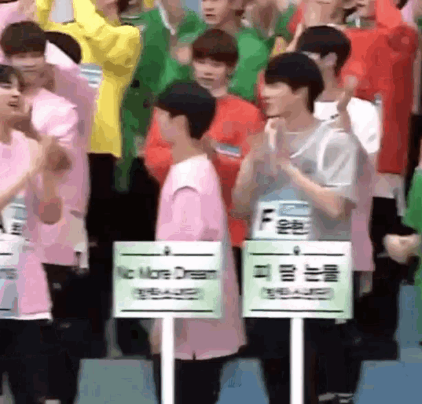 a group of people applauding in front of signs that say no more dream